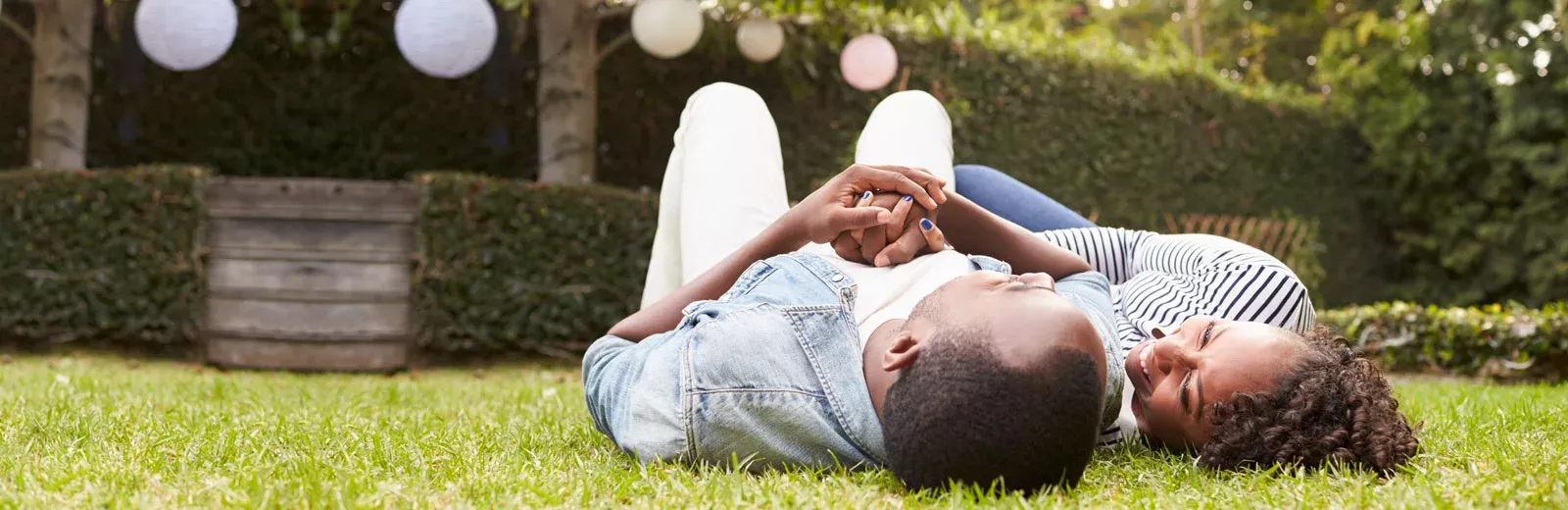 Couple outside lying in grass