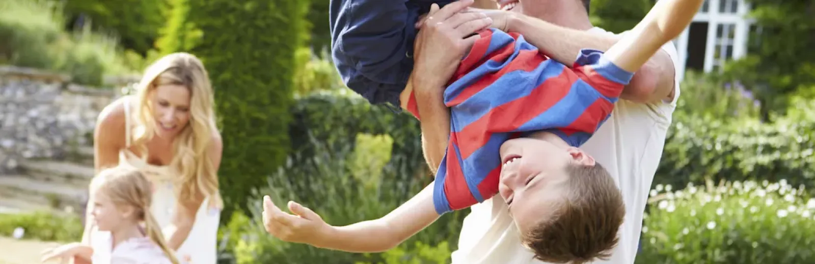 Family playing in green yard