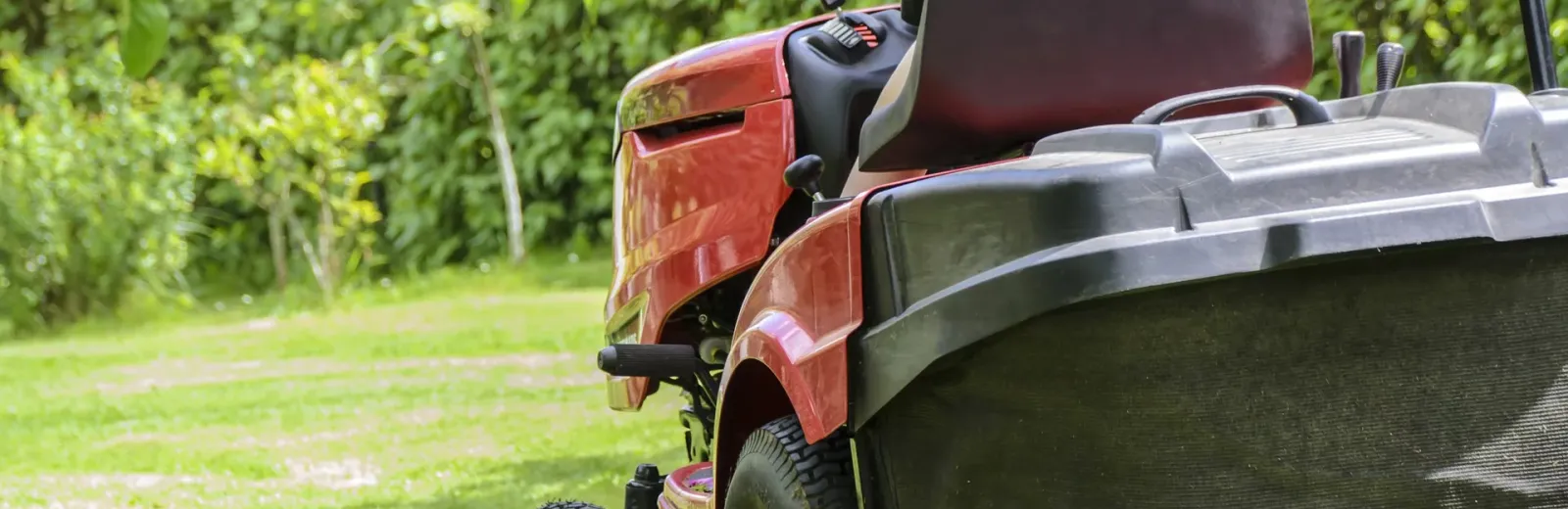 Someone mowing healthy green grass